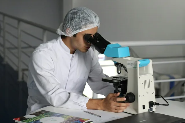 A researcher at a microscope